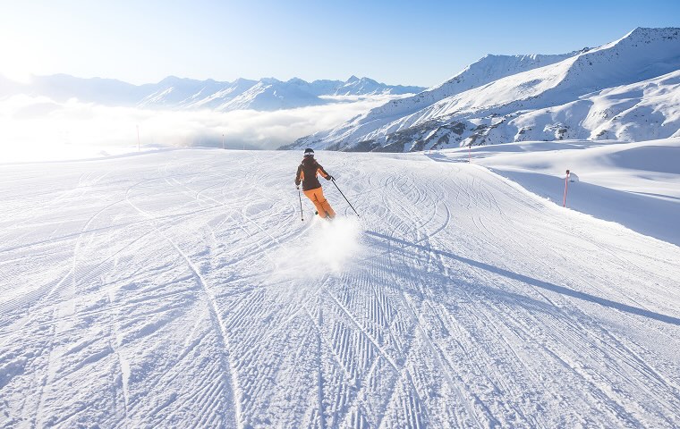 A person skiing down a snowy mountain